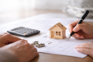 Calculator, pen and paperwork for Seller Financing